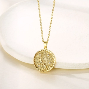 Macro detail of gold flower coin pendant necklace with sparkling cubic zirconia accents