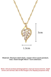 Macro view of gold leaf pendant with micro-pave zircons and detailed leaf veins