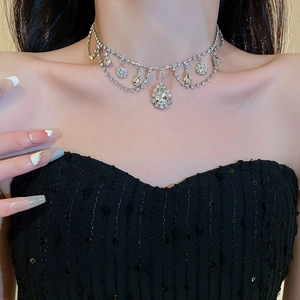 Close-up of luxury teardrop rhinestone choker with elegant multi-layer silver tassels