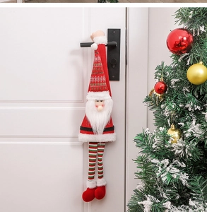 Plush Santa door handle hanger with long legs on a modern black handle for Xmas decor