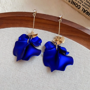 Detail of Klein blue petal tassel earrings with gold finish and zircon stones