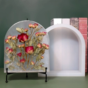 Macro detail of arch silicone mold with a finished dried rose resin artwork on metal stand