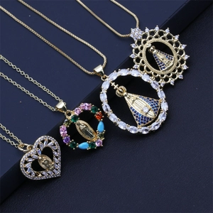 Detailed view of four gold-plated Virgin Mary pendants with colorful zircon stones