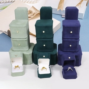 Detail of octagonal velvet jewelry box stack with pearl clasp and luxury lining