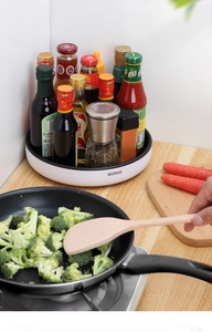 Rotating kitchen spice organizer tray made of heat-resistant plastic by a stove