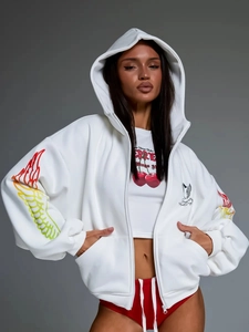 Detail of white oversized hoodie featuring colorful wing prints and zip closure