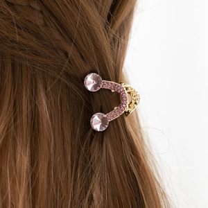 Pince à cheveux en U rose avec strass et grands cristaux sur cheveux bruns