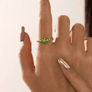 Adjustable gold leaf ring with green zirconia stones shown on a model's hand