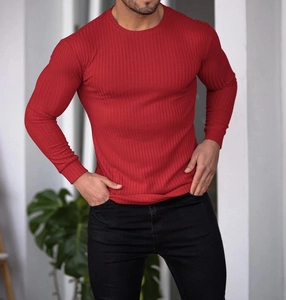 Detail of red slim fit long sleeve T-shirt showing ribbed fabric texture and crew neck