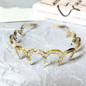 Macro view of wave headband featuring amber marble texture with black crackle patterns