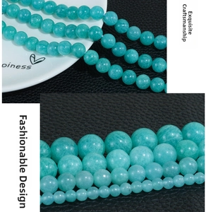 Macro shot of natural amazonite round beads in various sizes with bright green luster