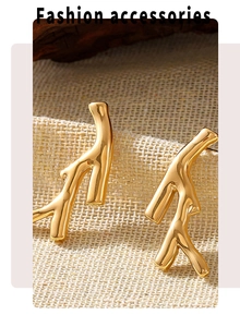 Macro detail of golden branch earrings with mirror finish on textured beige linen background