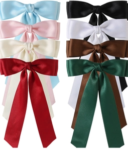 Flat lay of colorful 4cm satin double bow hair clips showing glossy silk ribbon texture