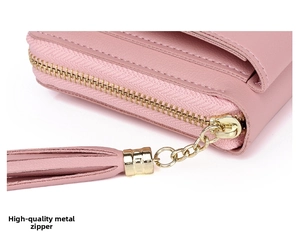 Detail of pink leather phone bag featuring a smooth gold zipper with tassel puller