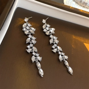 Close-up of elegant silver tassel earrings featuring marquise-cut rhinestones on a tray