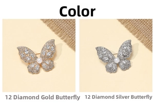 Detail view of gold and silver butterfly brooches with 12 crystals and white pearls