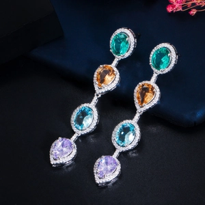 Detail of long teardrop earrings with multi-colored crystals and zircon paving