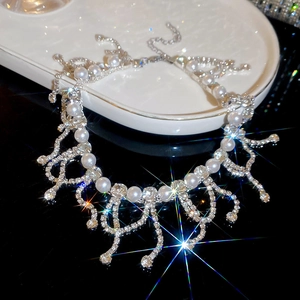 Macro detail of luxury pearl necklace with rhinestone tassel fringe and star flare effect