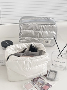 Waterproof quilted cosmetic bag with metallic finish and spacious zip compartment
