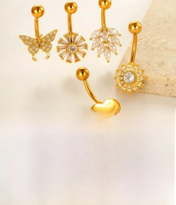 Detail of sunflower and butterfly belly rings with sparkling cubic zirconia in gold and silver