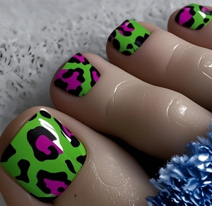 Detail of neon green press-on toenails with vibrant fuchsia and black leopard patterns