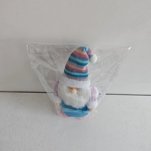 Detailed close-up of a creative Christmas snowman doll with a colorful knitted hat