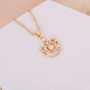 Elegant gold crown heart necklace with shimmering cubic zirconia on white display