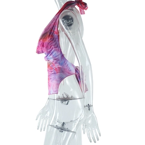Detail of colorful tie-dye halter crop top with back lace-up straps and open back design