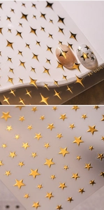 Detail of gold star nail art stickers M-004 featuring 3D metallic foil and star patterns