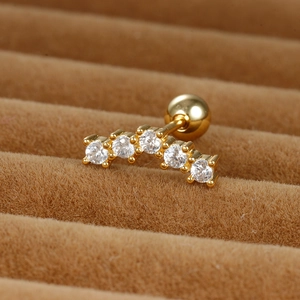 Macro view of gold stainless steel stud earring with five curved zircon stones and ball screw back