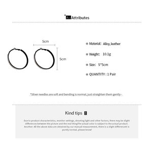 Detail view of 5cm black leather circle earrings showing alloy texture and size specs