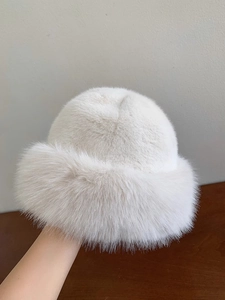 Close-up of thick white faux fur texture on a warm winter bucket hat for women