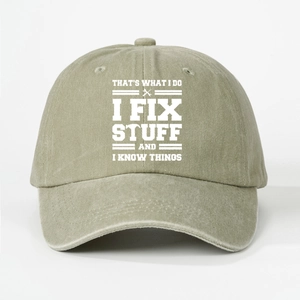 Detail of I FIX STUFF text and tool icons on a vintage washed khaki baseball cap