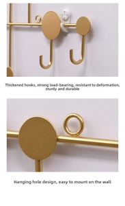 Detail of matte gold J-shaped metal hook with sturdy round base and ring hole design