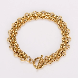 Detail of minimalist gold-plated double-layer chain bracelet with industrial OT clasp toggle
