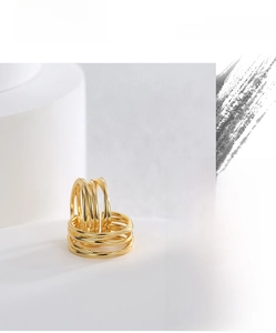 Macro shot of multi-layer winding gold ring with high-polish metallic finish details