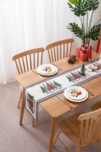 Close-up of a festive Christmas table runner featuring Merry & Bright digital printing