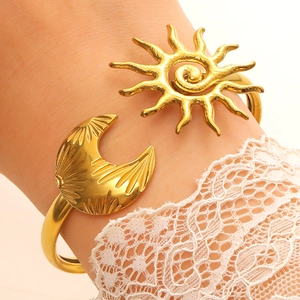 Golden stainless steel celestial cuff bracelet featuring sun and moon charms for women