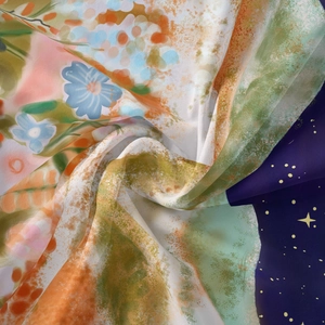 Detail shot of lightweight floral chiffon fabric with moon and stars patterns on the surface