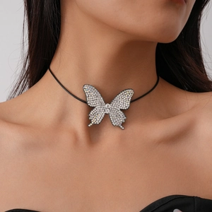 Close-up of sparkling rhinestone butterfly choker necklace on model's neck