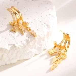 Detail of gold-plated triple hoop earrings with pink zircon stars and geometric pendants