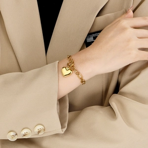 Chic 18K gold titanium heart pendant bracelet with OT toggle clasp worn by a fashion model