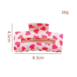 Pink heart print hair claw clip made of acetate with size dimensions and weight display