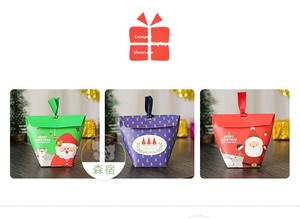 Detailed view of Christmas cookie gift boxes with festive reindeer and Santa prints