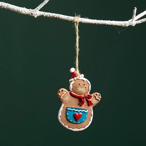 Resin gingerbread man ornament with red scarf on branches for Christmas tree decoration