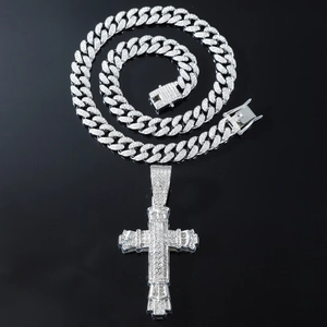 Silver iced out cross pendant with sparkling rhinestones on a matching Cuban link chain