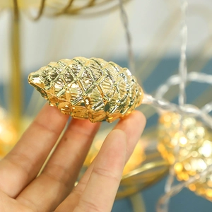 Golden pinecone LED fairy lights for Christmas tree decoration with warm festive glow