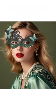 Close-up of green lace masquerade mask with butterfly, pearls and rhinestone details