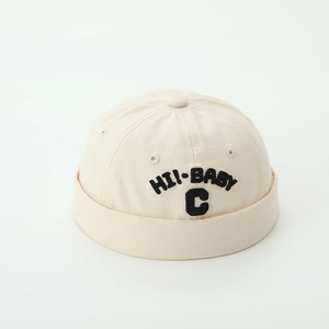 Detail of beige cotton Miki hat showing black 3D embroidered letters HI!-BABY and C