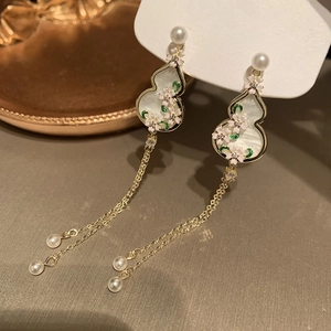 Elegant Chinese-style gourd earrings with floral patterns, pearls, and long golden tassels